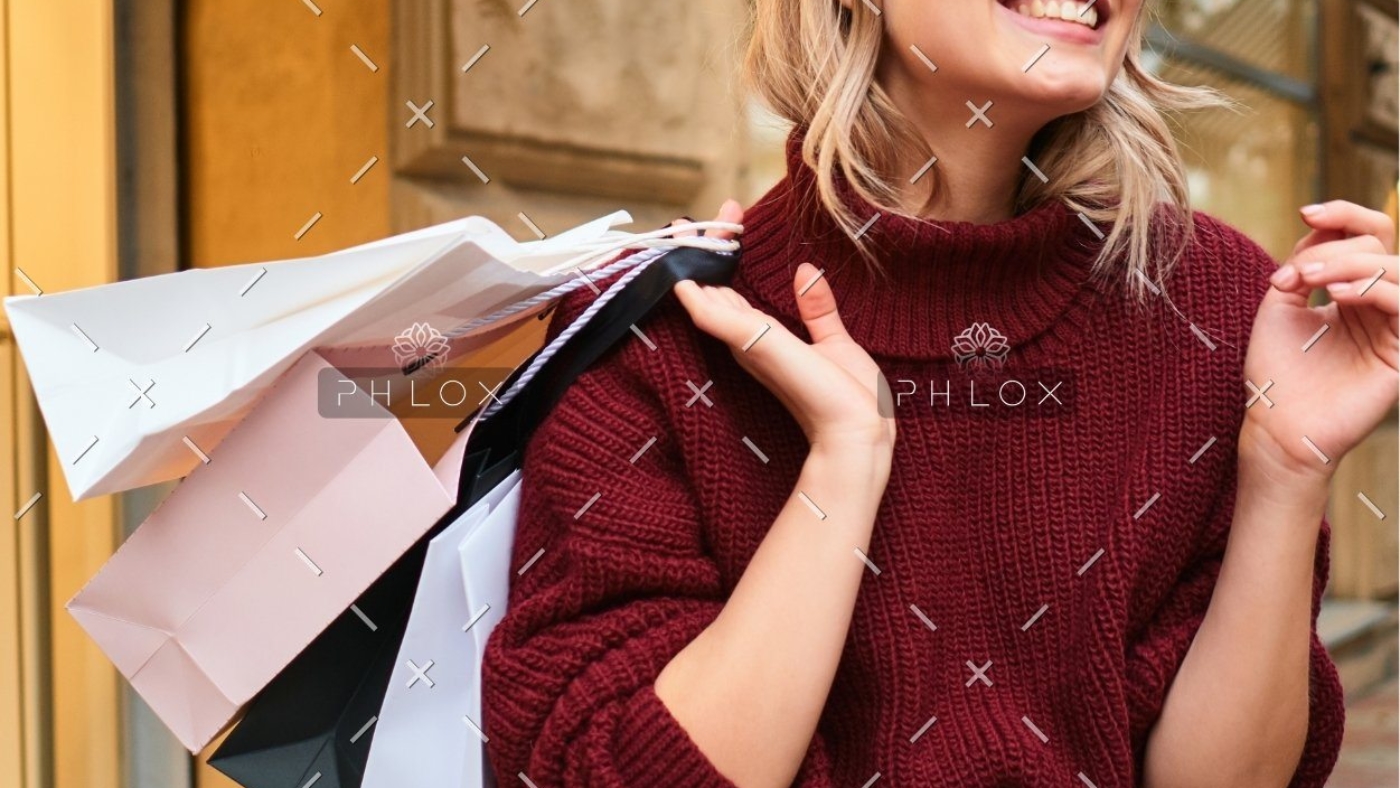 demo-attachment-523-cheerful-girl-in-knitted-sweater-with-shoppi-JWHCW3Y